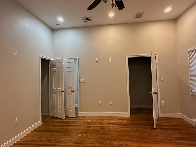 Master bedroom back wall view : closet on left , doorway to hall and walk in catheral closet on the right .