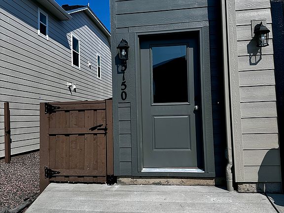 Front door with parking pad in front.
