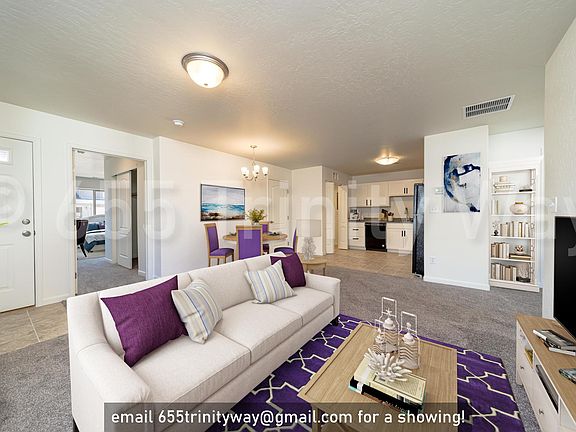 light-filled combo living space with tiled entryway and kitchen