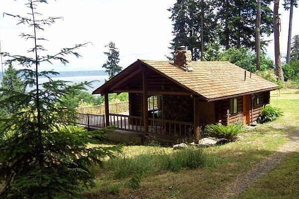 Log cabin with river stone fireplace
