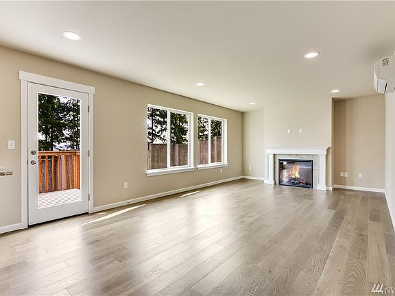 The light and bright living room has amazing engineered hardwood floors and an efficient electric fireplace.