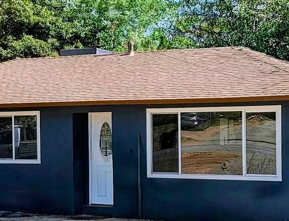 Freshly painted exterior with a welcoming front entry and large front window.