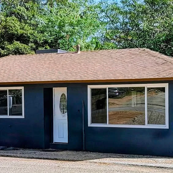 Freshly painted exterior with a welcoming front entry and large front window.