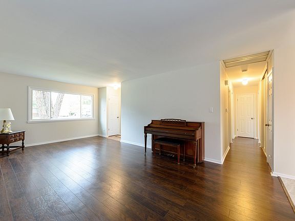New flooring and paint set off this large living room that could also hold a dining table.