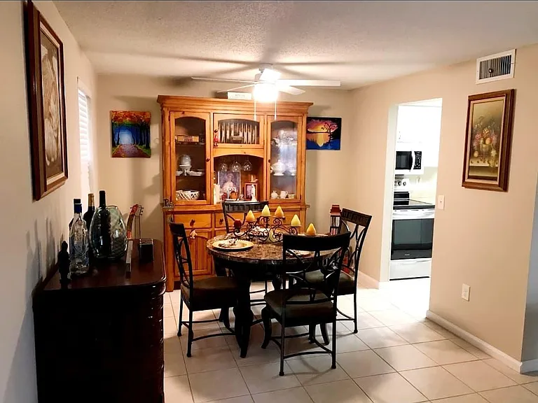 Dining Room with access to kitchen and family room. New ceiling fan and faux window 
blind.