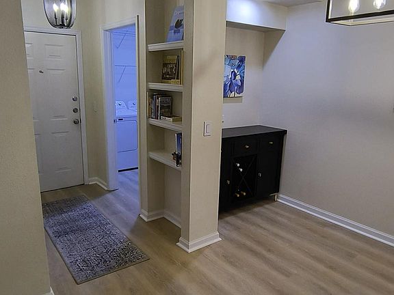 Condominium entrance hall with built-in shelving.