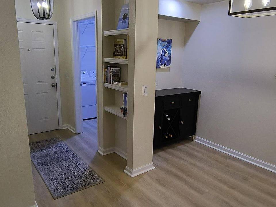 Condominium entrance hall with built-in shelving.