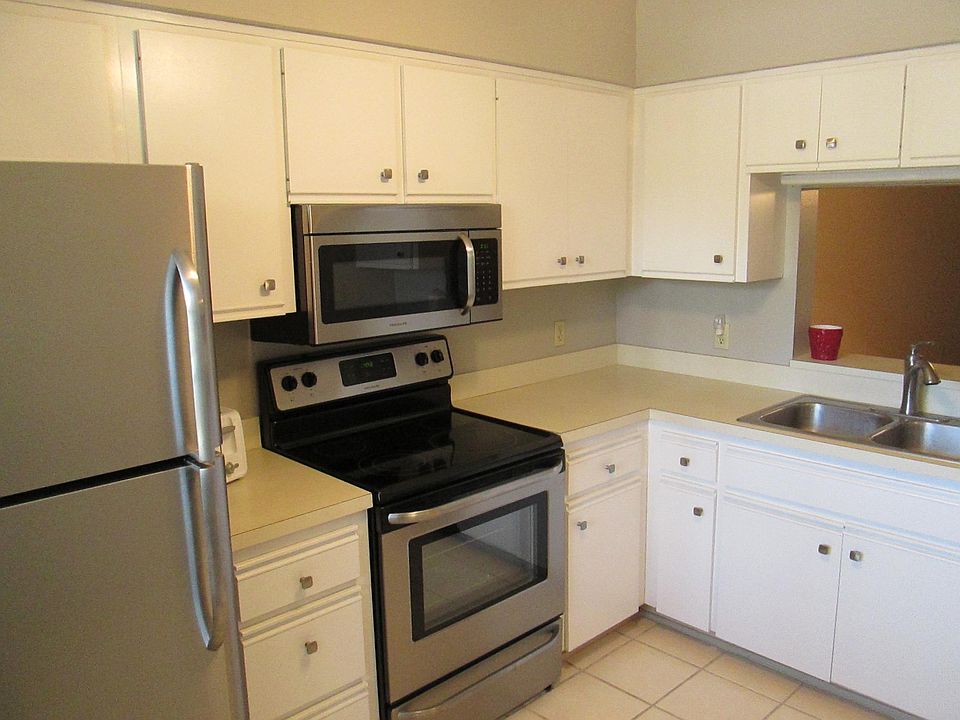 White kitchen with stainless appliances