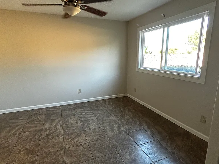Master, showing ceiling fan and large window- plenty of natural light!