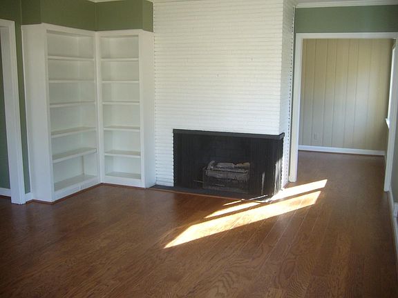 Living Room with a gas log fireplace and built-ins