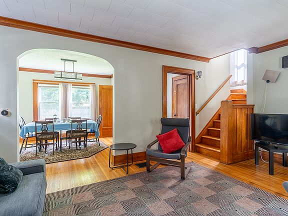 Living room showing dining room overlooking back yard, stairs to second floor. All furniture shown is included.