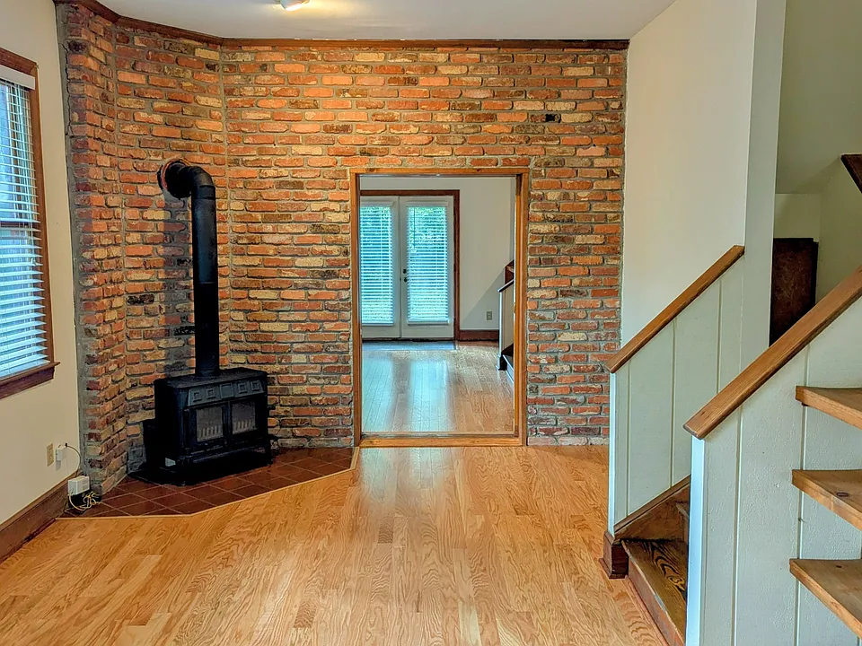 Front room with cast iron stove. Pocket divider glass and wood door not shown in pic.