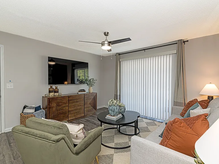 Spacious living room with hardwood-style flooring & overhead lighting