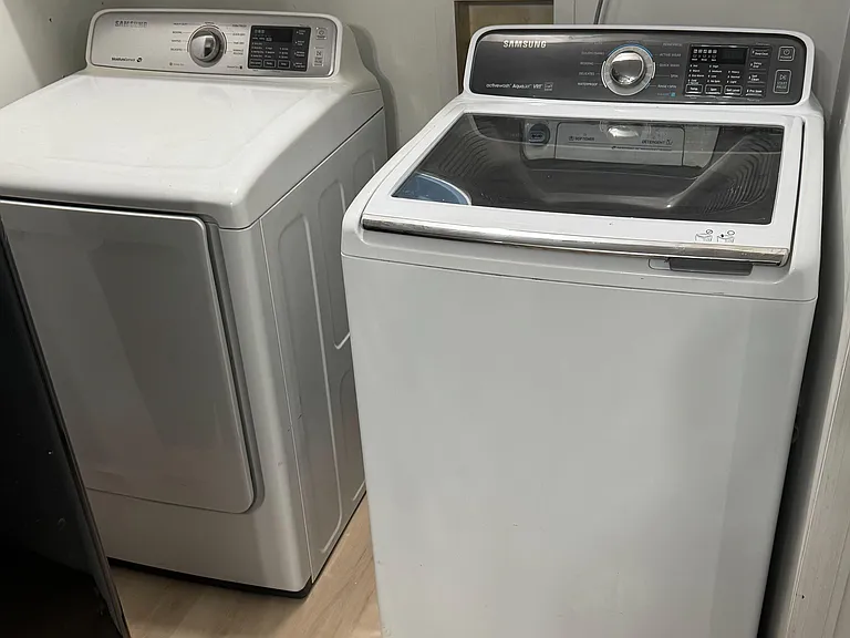 Dedicated laundry nook with a full-size washer and dryer for convenient in-home laundry.