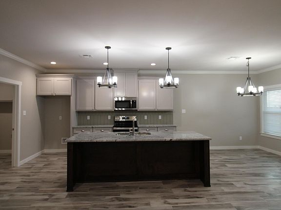 Gorgeous kitchen with granite counters, island and dining room