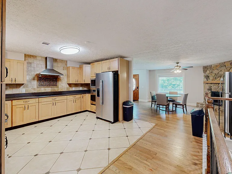 Open kitchen with generous cabinet storage, stainless appliances, and adjacent dining area with window views.