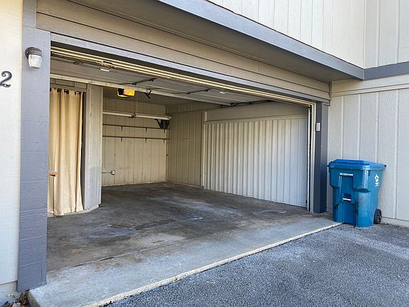 One car garage with small storage area.