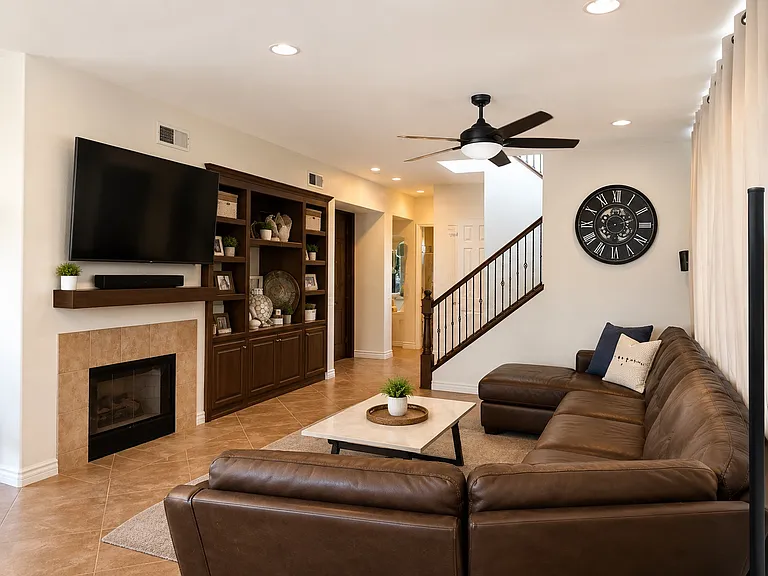 Living room with built in entertainment center and fireplace