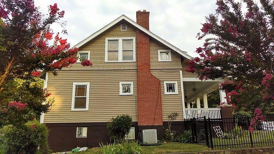Original decorative fireplace and lots of windows throughout.