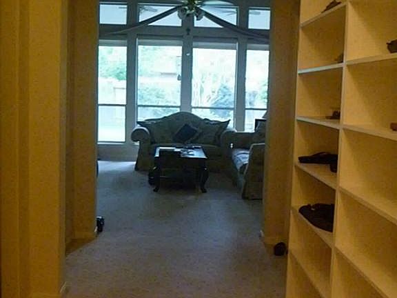 ENTRY WITH WALL OF SHELVES