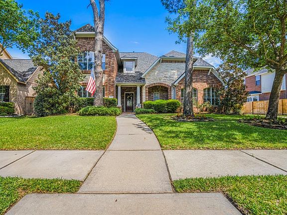 Located on a quiet cul-de-sac street with a beautiful front stacked stone elevation with an inviting front porch & mature landscaping.