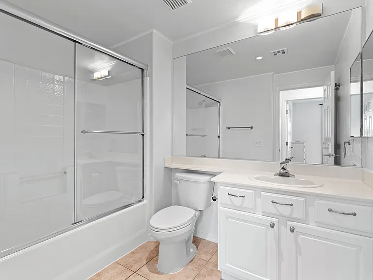 hall bath has full shower/tub with upgraded glass