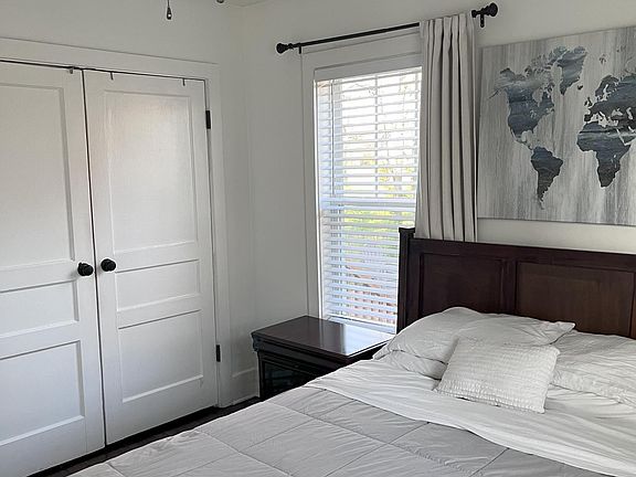 Bedroom with ceiling fan and large closet.