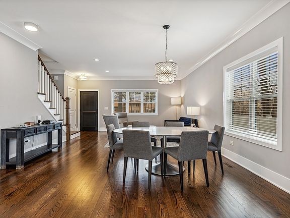 Dining area in foreground with living & entry in b