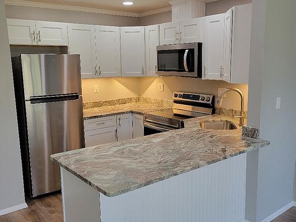 New kitchen cabinets, appliances, granite counter tops, bar.