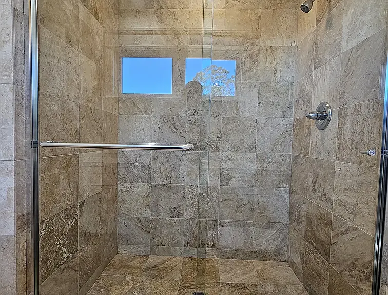 Downstairs shower with glass shower door