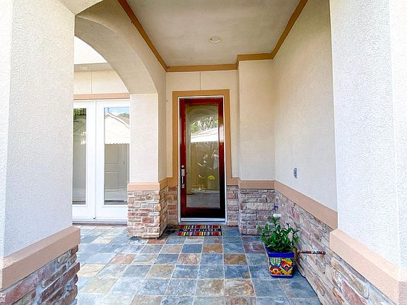 Covered portion of patio. Glass door entrance to home.