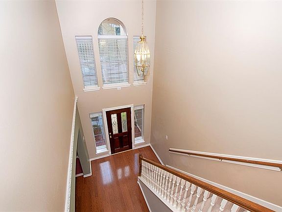 An impressive entrance is created with the high-ceiling, transom windows, beveled glass front door and sidelights. There are 2-inch wood blinds on the sidelights to control both light and privacy.