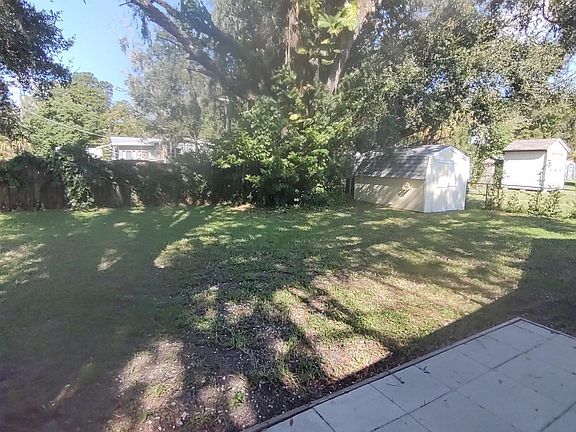 view of backyard and shed from patio