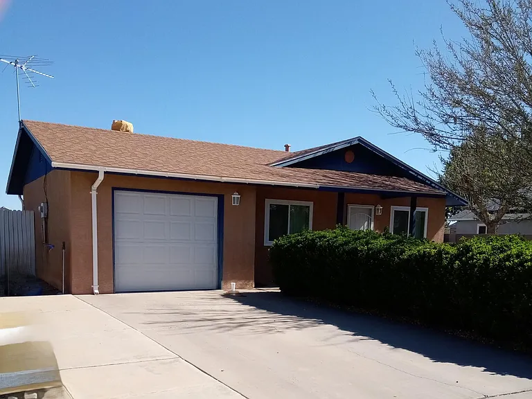 Front of house with single car attached garage.