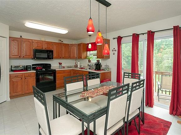 The eat in kitchen has glass sliding doors leading out to the deck.