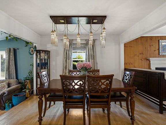 Dining area connecting the living room and den, with open access to the kitchen.