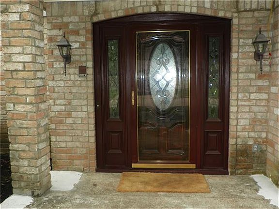 Beautiful Lead Glass doors greet you. There is also a protective storm door to protect the wood from the Houston elements - less work for you and better insulation too.