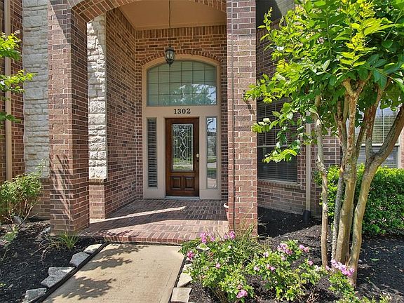 An oversized, covered entry with lead glass door welcomes guests, family and friends.