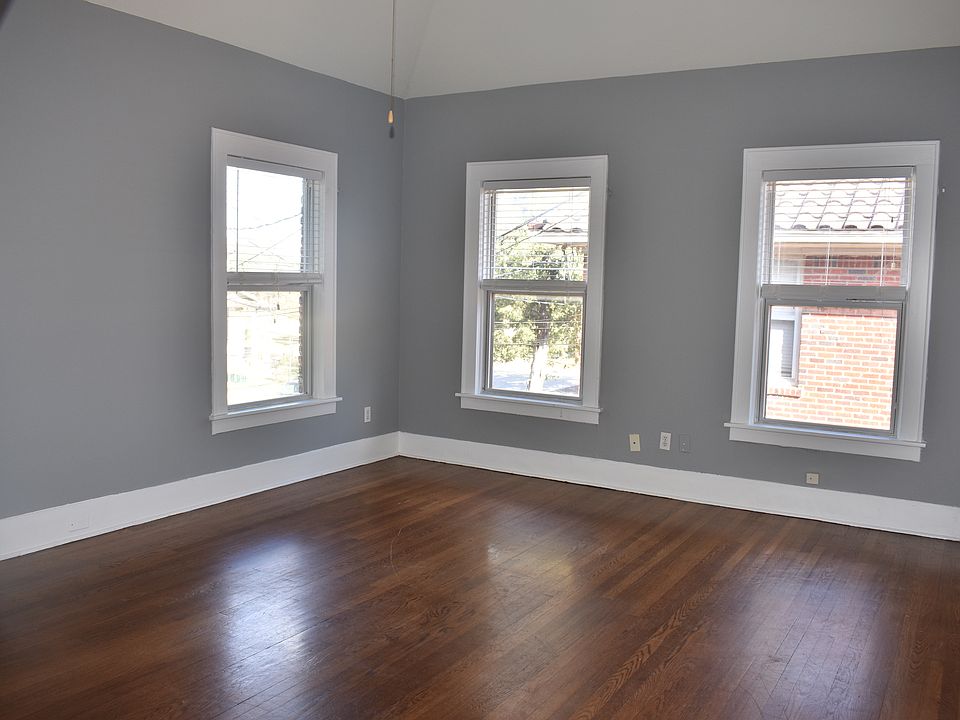 View from front door of den with vaulted ceilings leading to loft with two rooms.
