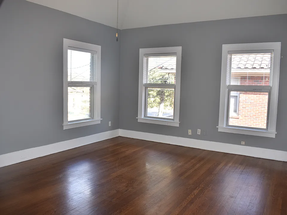 View from front door of den with vaulted ceilings leading to loft with two rooms.