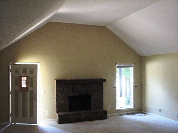 Vaulted great room (living/dining combination) with working fireplace
