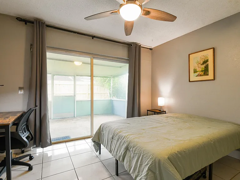 Full size cozy bed, with end table, light and storage container under the bed. Black out curtains for your own sliders