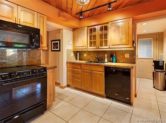 Granite tops with pretty kitchen wood cabinets