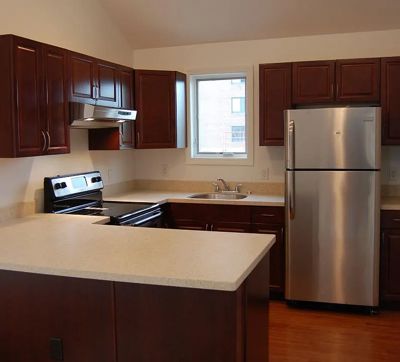 Brand new kitchen with stainless steel appliances and vaulte