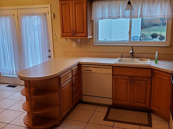 Kitchen with a large window looking out to backyard.