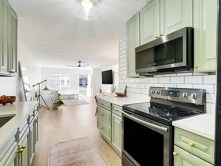Enjoy cooking in this inviting kitchen with granite counters, stainless appliances, and an open design that lets you stay engaged with the living area.
