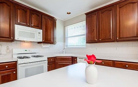 Well-designed kitchen w/42" cherry cabinets and center island.