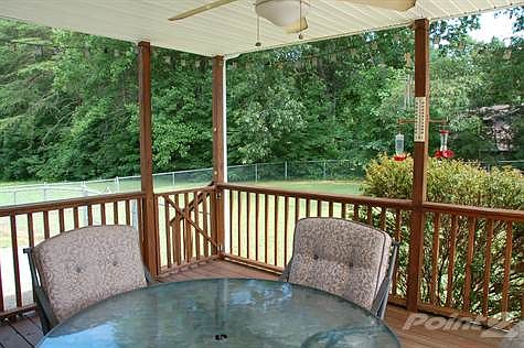 rear deck with fenced in yards and extra land