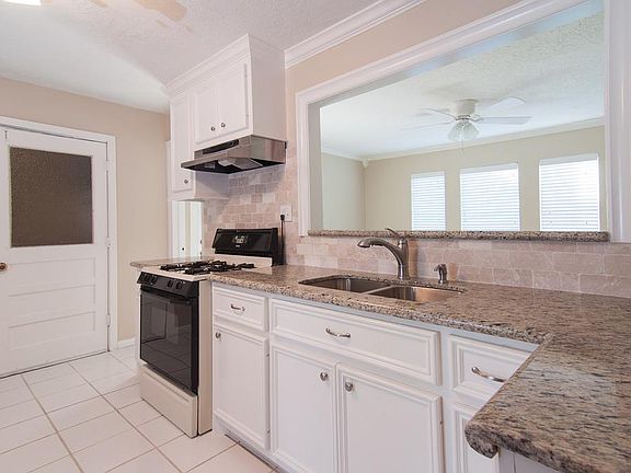 Granite countertops, tumbled marble backsplash and stainless steel undermount sink.