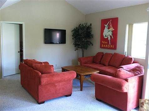 Living room with sofa sleeper, flat screen tv, vaulted ceili